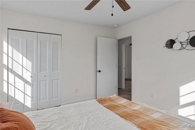 bedroom with ceiling fan and a closet