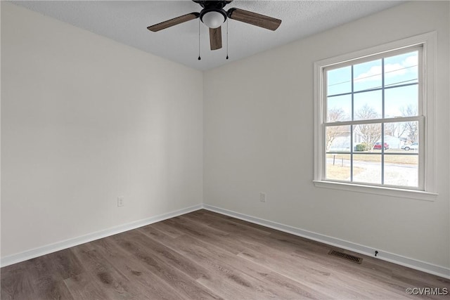 unfurnished room with hardwood / wood-style flooring, a textured ceiling, and ceiling fan