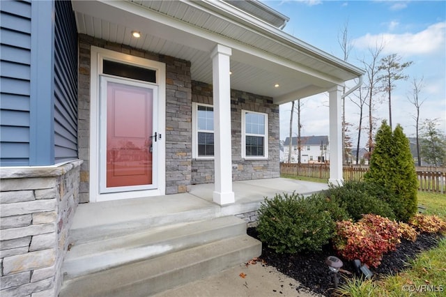 view of exterior entry featuring a porch