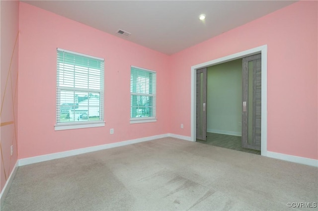 unfurnished bedroom featuring light carpet