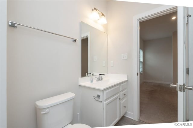 bathroom featuring vanity and toilet