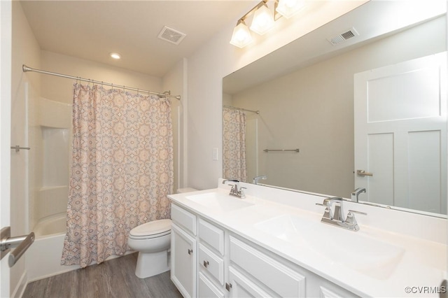 full bathroom featuring shower / tub combo with curtain, vanity, wood-type flooring, and toilet