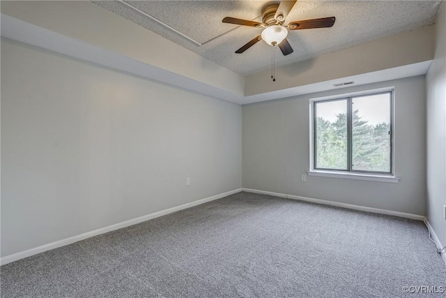 spare room with ceiling fan, carpet floors, and a textured ceiling