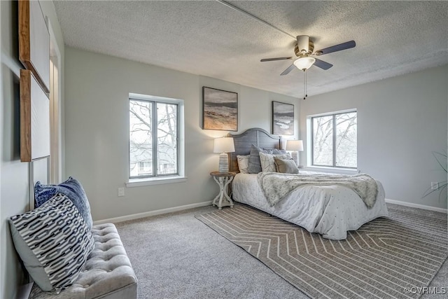 bedroom featuring multiple windows, a textured ceiling, and carpet