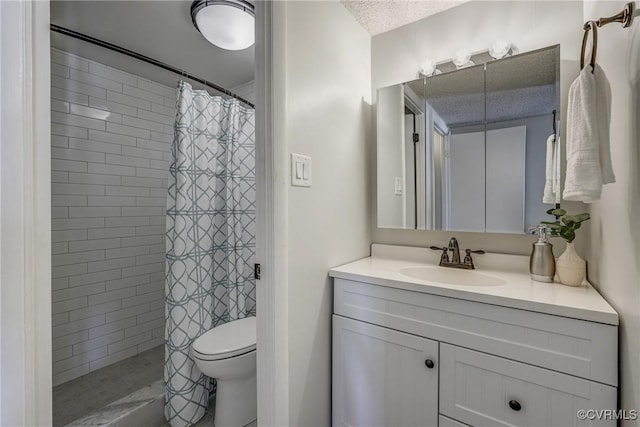 bathroom featuring vanity, a textured ceiling, toilet, and walk in shower