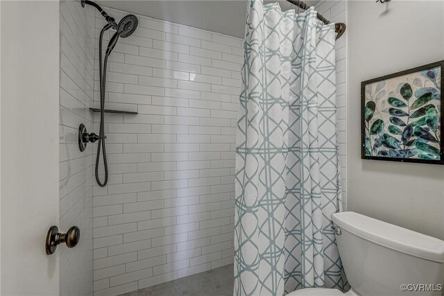 bathroom featuring toilet and a shower with shower curtain