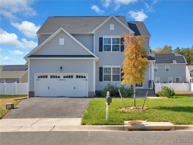 view of front of property featuring a garage and a front lawn