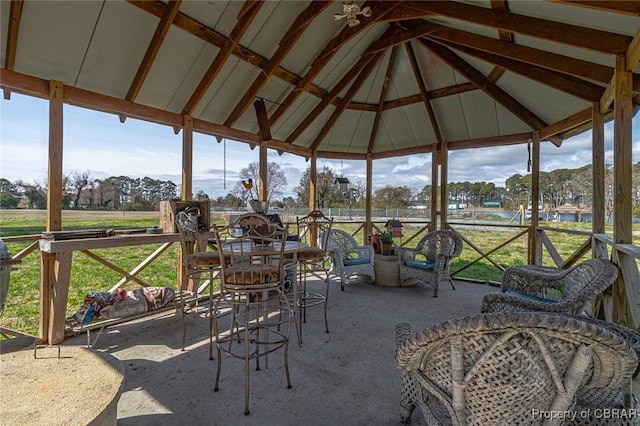 sunroom featuring vaulted ceiling