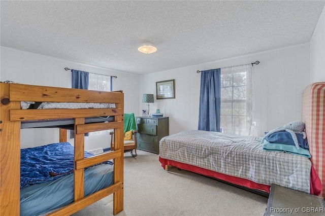 bedroom featuring carpet floors and a textured ceiling