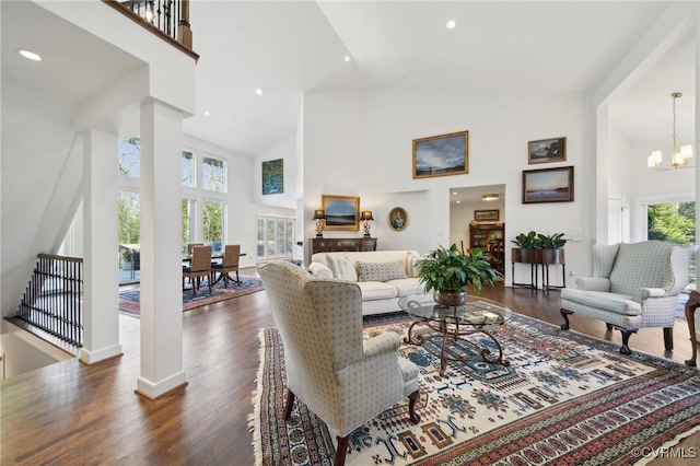 living room featuring a high ceiling, dark wood-style flooring, recessed lighting, and an inviting chandelier