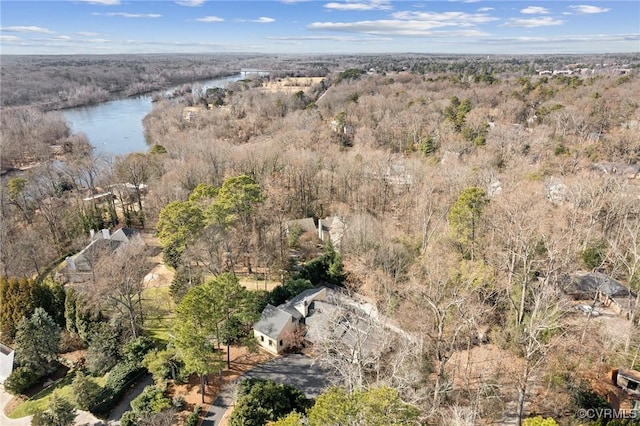 birds eye view of property featuring a water view and a view of trees