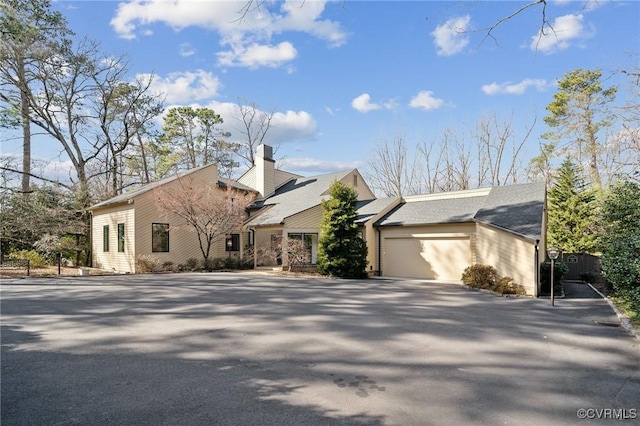 view of front of house featuring aphalt driveway and a garage