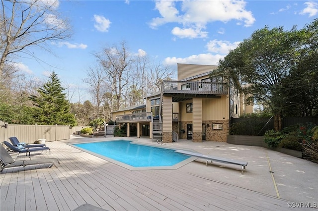 view of pool with a fenced in pool, a patio, stairway, fence, and a deck