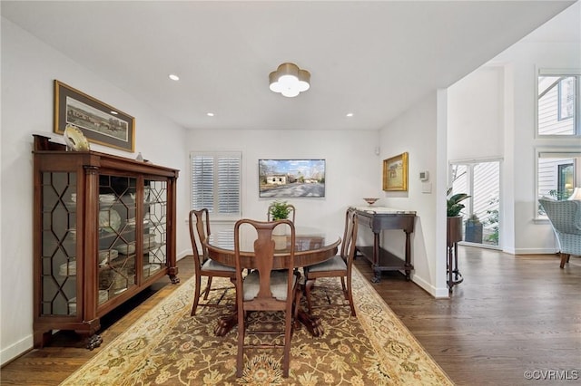 dining space with baseboards, dark wood-style flooring, and recessed lighting