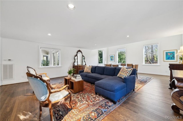 living area with recessed lighting, dark wood finished floors, visible vents, and baseboards