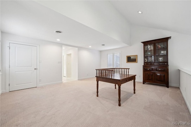 office space with recessed lighting, visible vents, vaulted ceiling, and light carpet