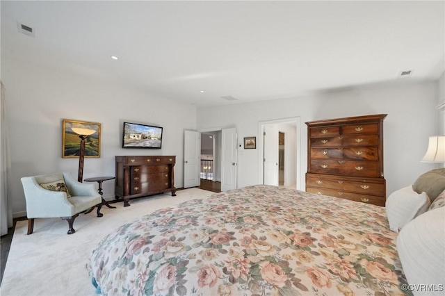 bedroom with light carpet, visible vents, and recessed lighting