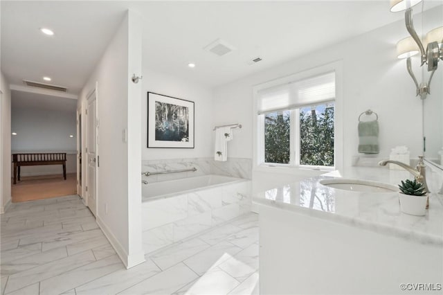 full bath with marble finish floor, a garden tub, recessed lighting, visible vents, and vanity