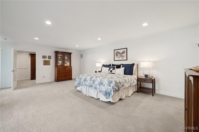 bedroom featuring recessed lighting, light colored carpet, and baseboards