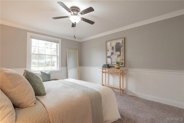 carpeted bedroom with crown molding and ceiling fan