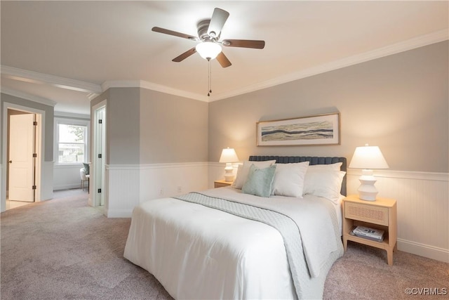 bedroom with crown molding, light colored carpet, and ceiling fan