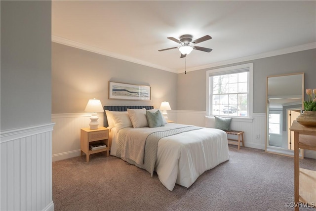 carpeted bedroom featuring ceiling fan and ornamental molding