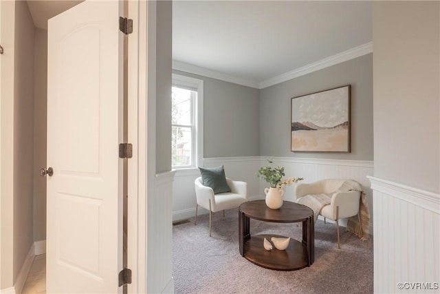 living area featuring ornamental molding and light carpet