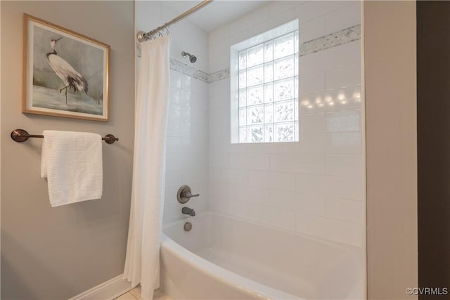 bathroom with shower / bath combo with shower curtain