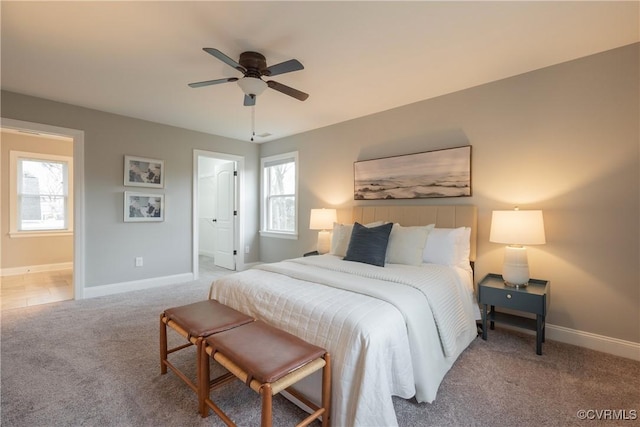 bedroom with carpet floors, ceiling fan, and ensuite bathroom