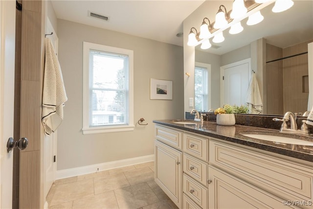 bathroom featuring an inviting chandelier, tile patterned floors, and vanity