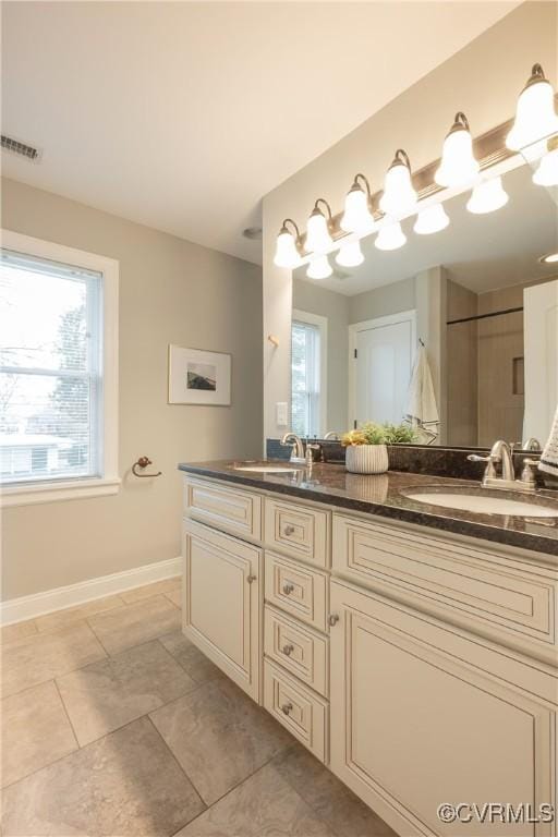 bathroom featuring tile patterned flooring and vanity