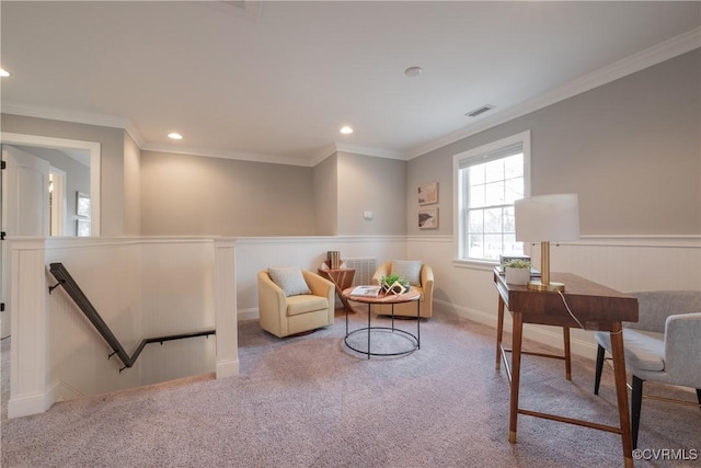 sitting room featuring ornamental molding and light carpet