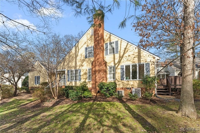 back of house with a lawn, central air condition unit, and a deck