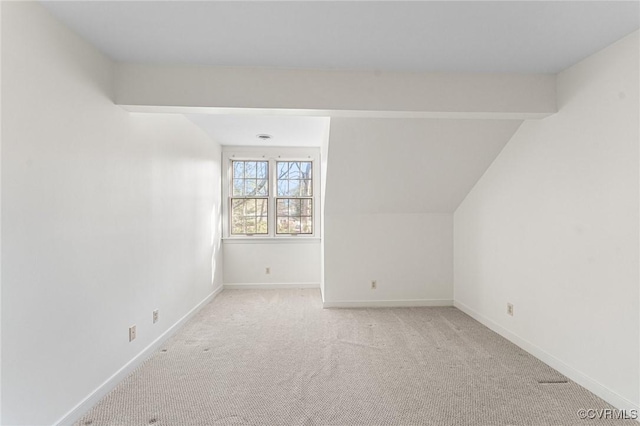 bonus room featuring lofted ceiling and light colored carpet