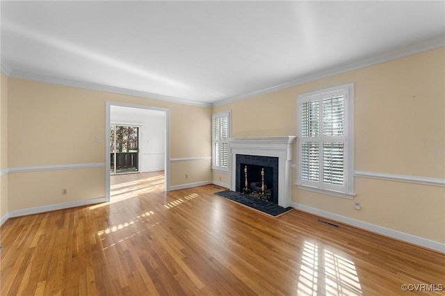 unfurnished living room with light hardwood / wood-style flooring and ornamental molding