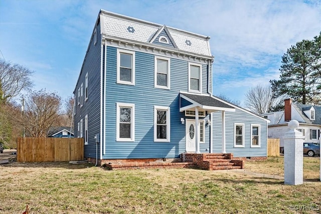 view of front of house with entry steps, a front lawn, and fence