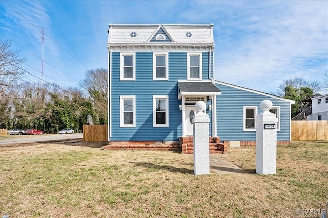 view of front of house with a front yard and fence