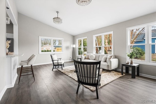 living area with vaulted ceiling, baseboards, dark wood-style floors, and a notable chandelier