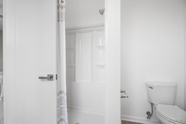 full bathroom with a shower stall and toilet