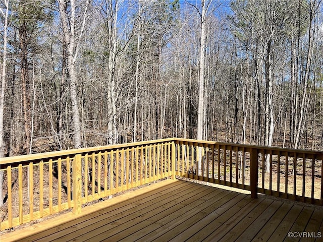 wooden deck with a view of trees