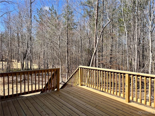 wooden deck with a wooded view
