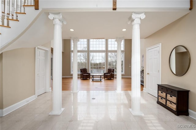 foyer entrance featuring decorative columns