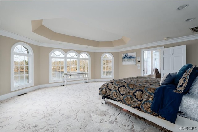 bedroom with a raised ceiling, ornamental molding, and light carpet