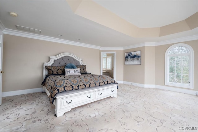 bedroom featuring a tray ceiling and crown molding