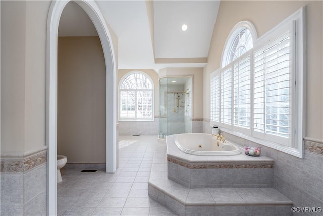 bathroom with tile patterned flooring, independent shower and bath, and toilet