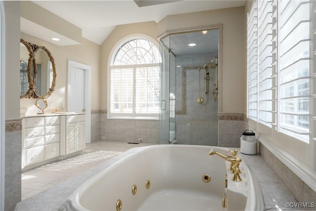 bathroom with lofted ceiling, vanity, separate shower and tub, and tile patterned floors