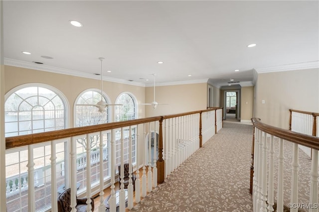 hallway featuring crown molding and light carpet