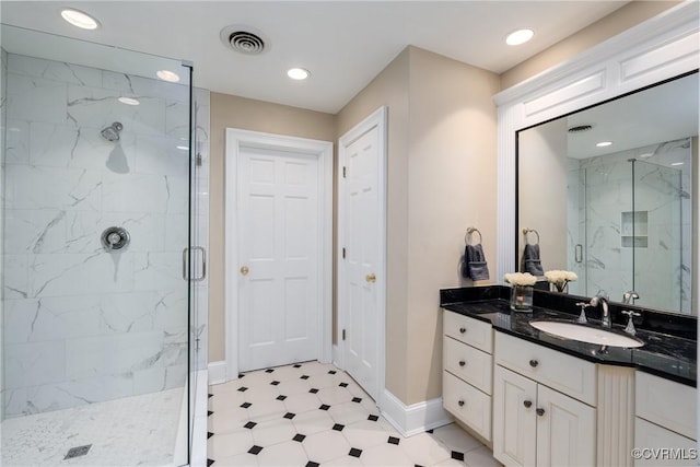 bathroom with vanity and a shower with door