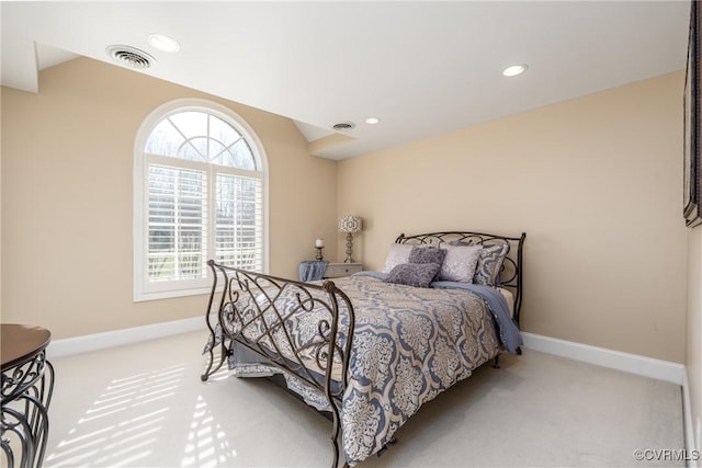 bedroom featuring lofted ceiling and light carpet