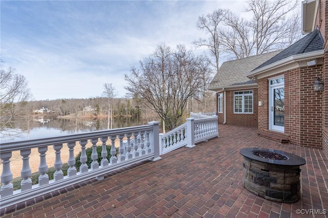 view of patio / terrace featuring a water view and an outdoor fire pit